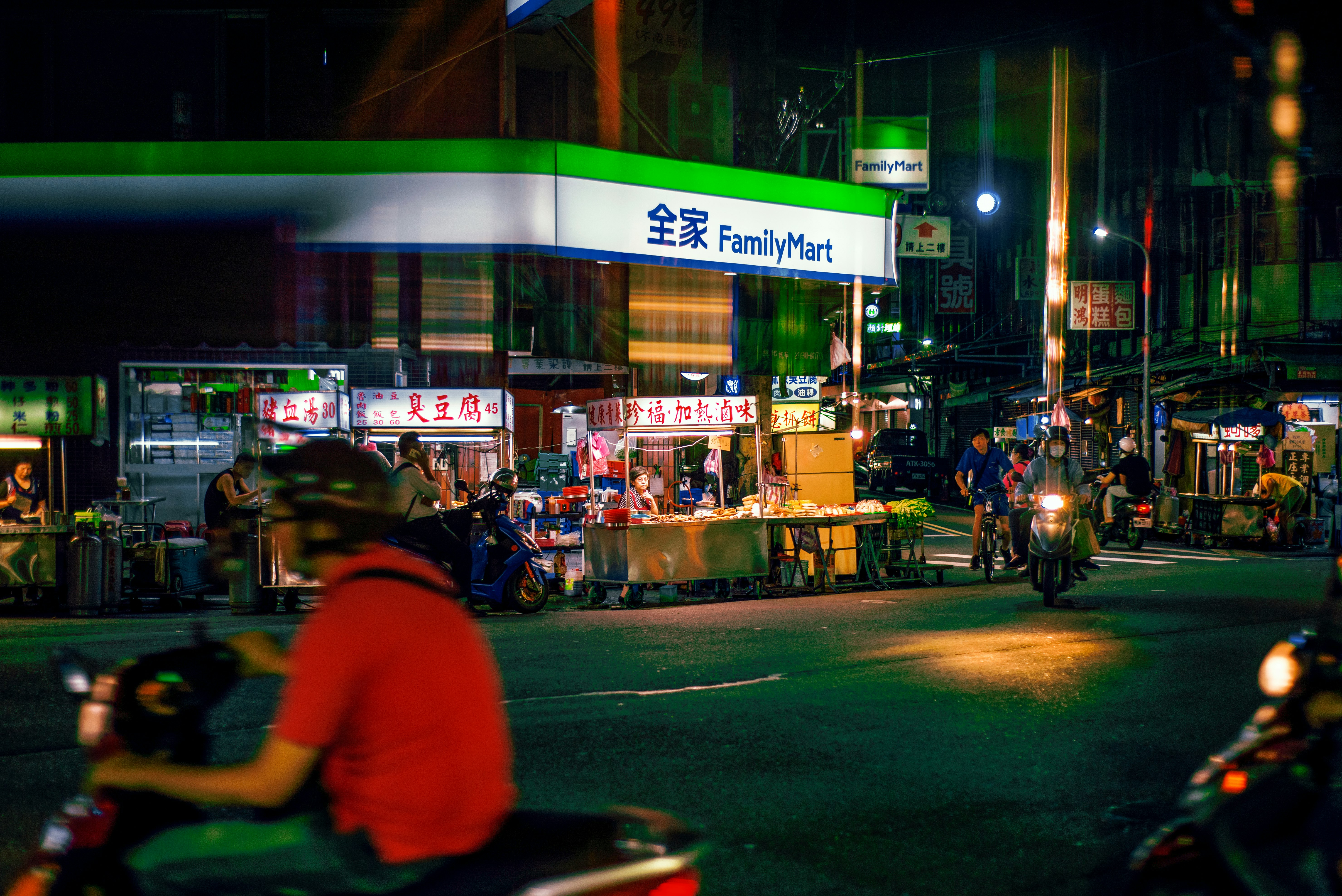 people in a green and white building during nighttime